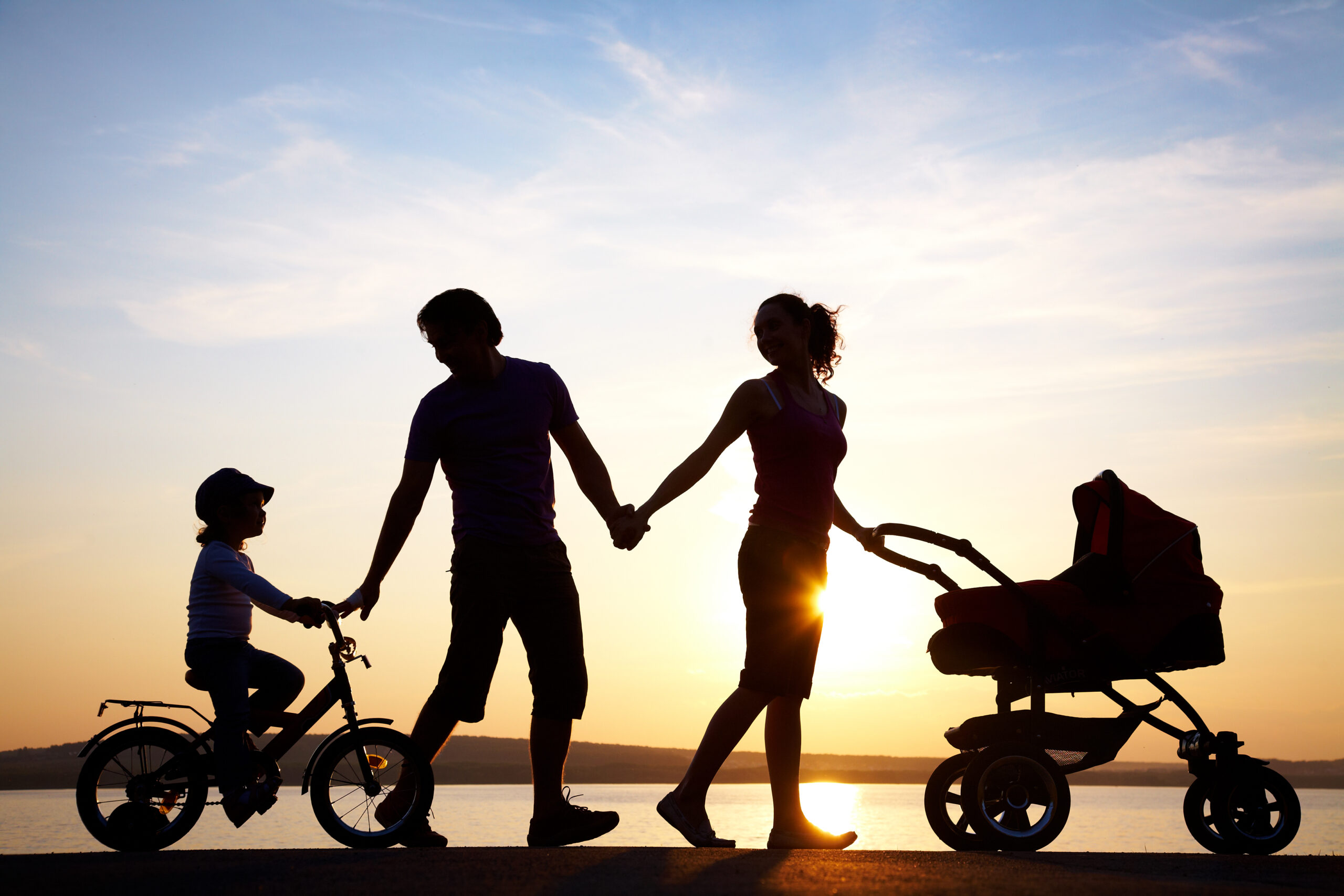 Happy family walking at sunset